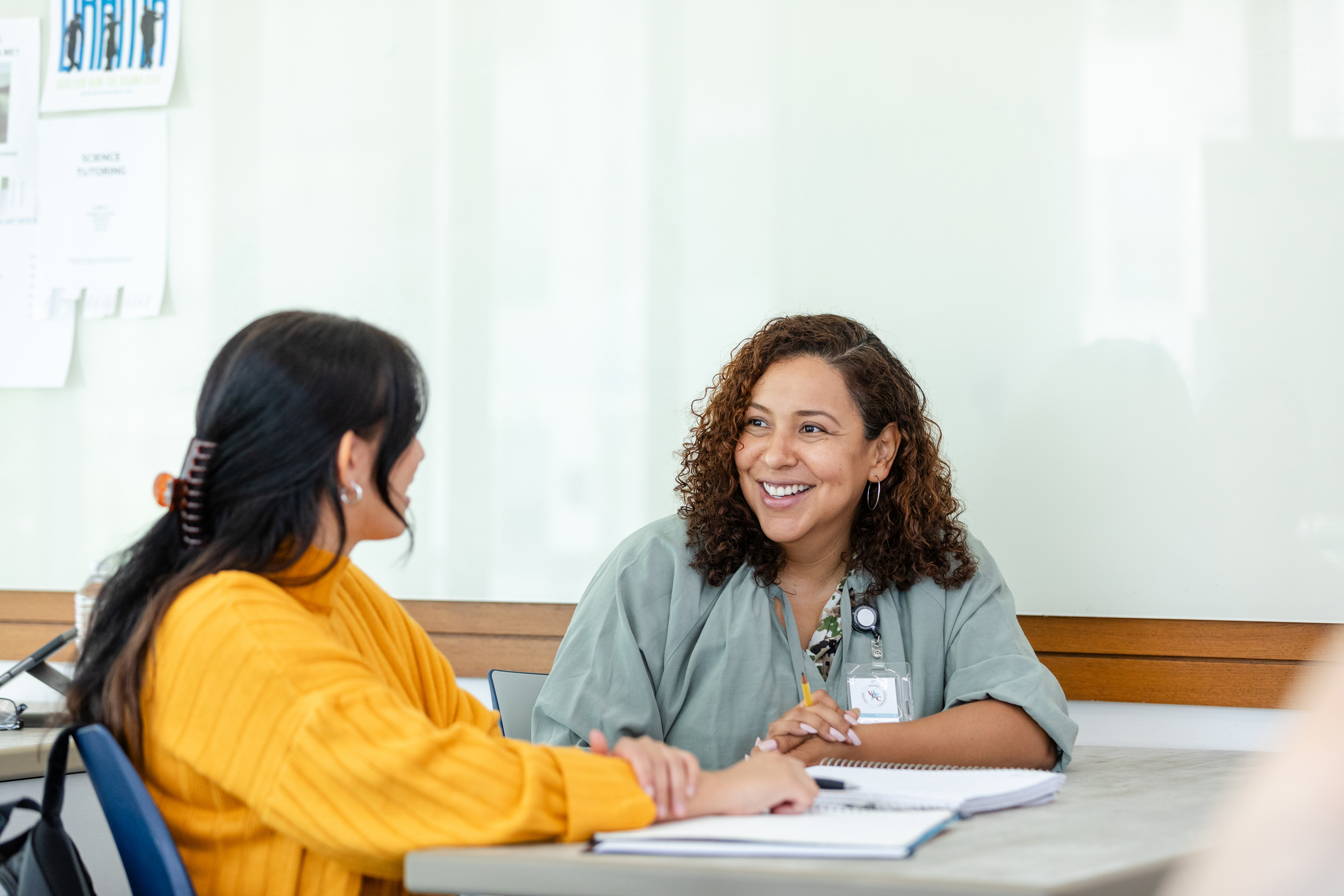 A healthcare worker speaking to a young lady